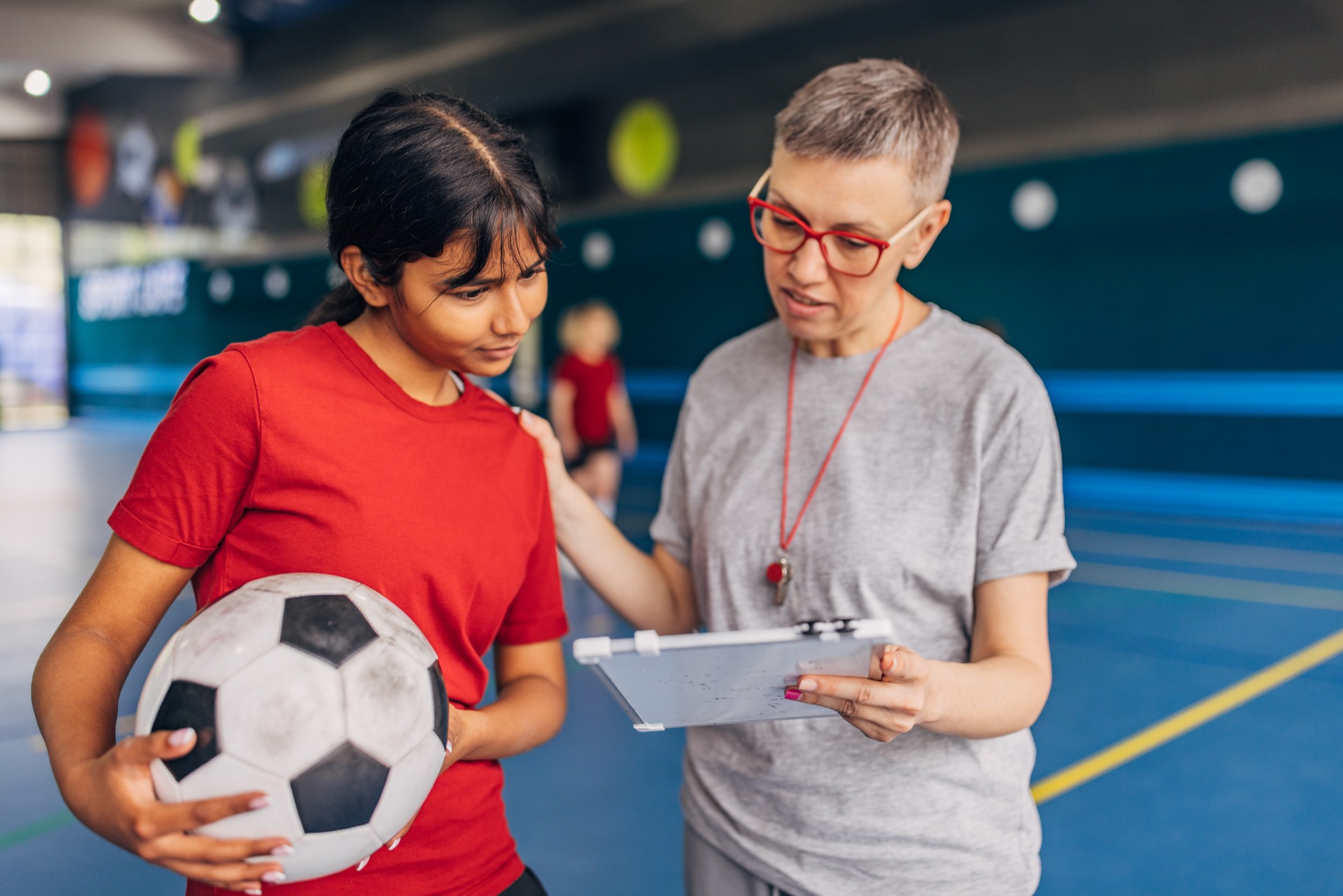 Soccer team player discussing strategy indoors court